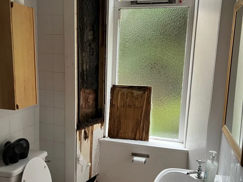 Bathroom in the Crosshill flat with the plasterboard removed beside the window